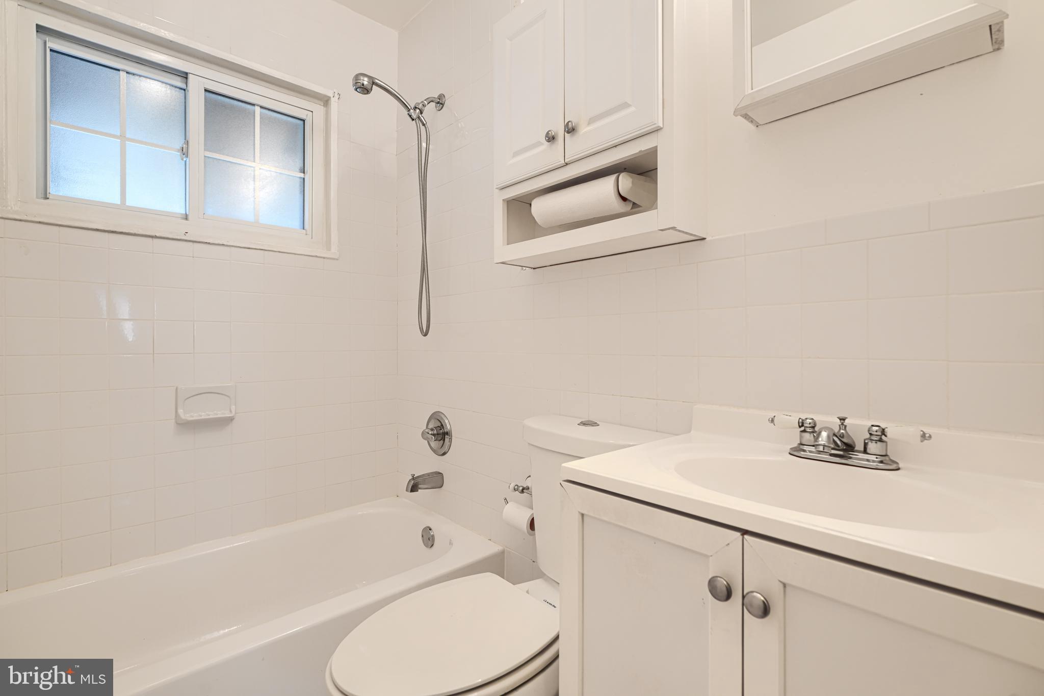 930 Sedgley Road Baltimore, MD 21228 - Photo 34 of 43 a bathroom with a sink a toilet and shower