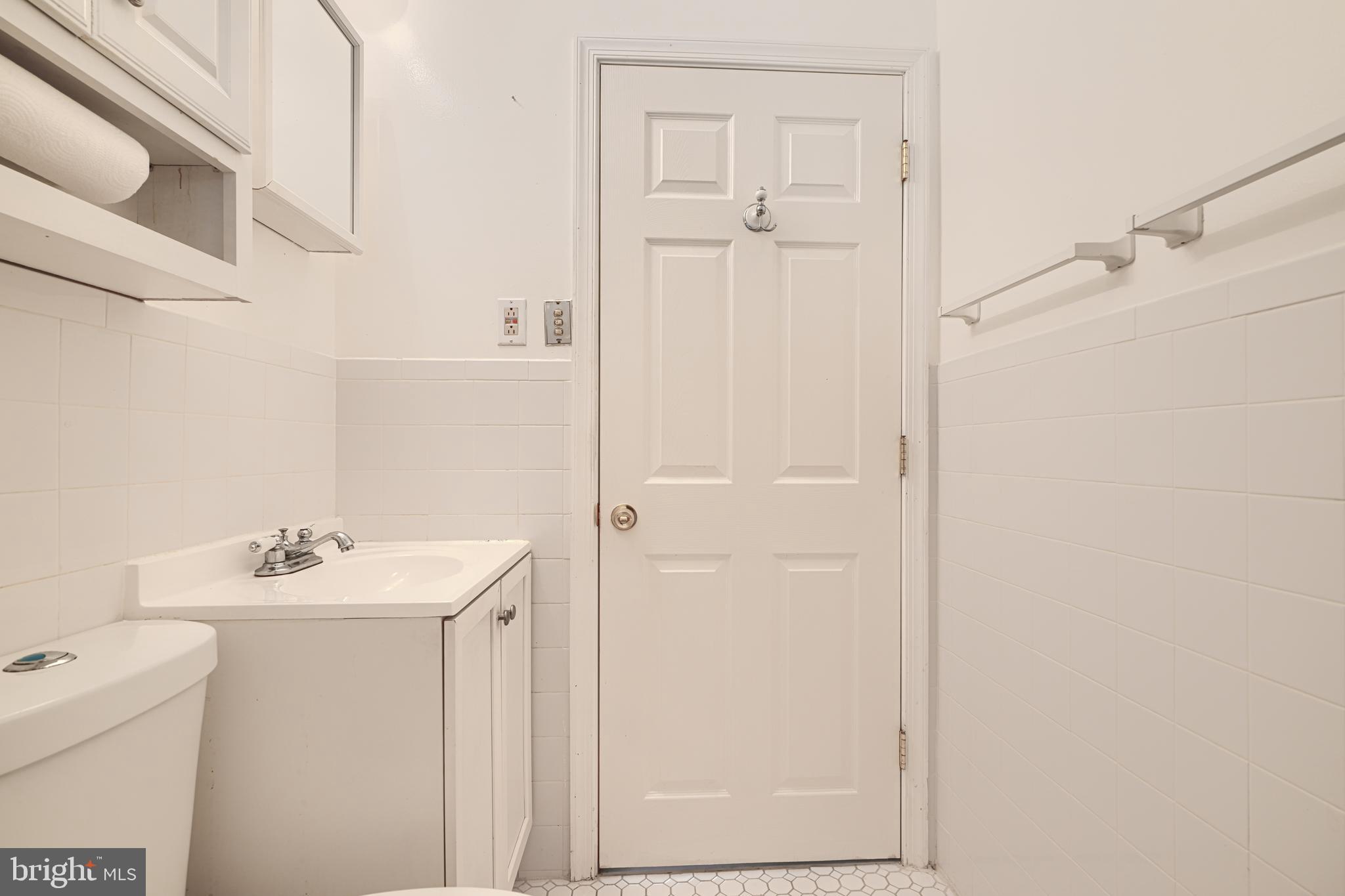 930 Sedgley Road Baltimore, MD 21228 - Photo 35 of 43 a bathroom with a sink a toilet and a mirror