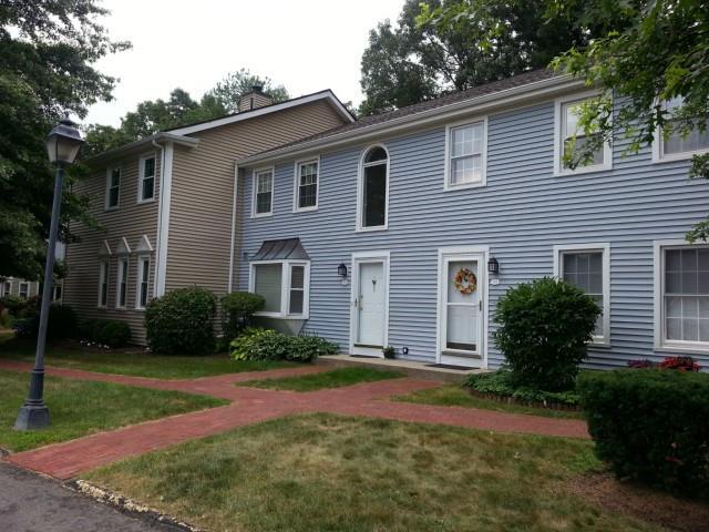 1 East Hayestown Road, Unit 63 Danbury, CT 06811 - Photo 1 of 1 a front view of a house with garden