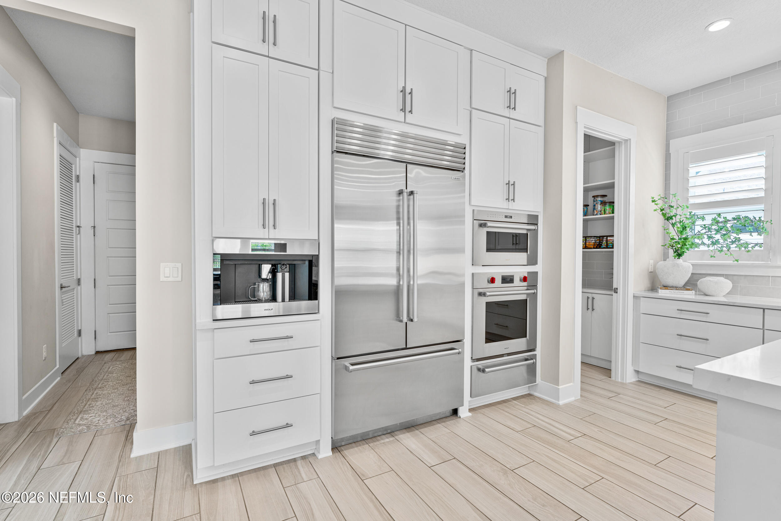 245 Ranch Land Circle St. Johns, FL 32259 - Photo 18 of 74 a kitchen with cabinets stainless steel appliances and wooden floor