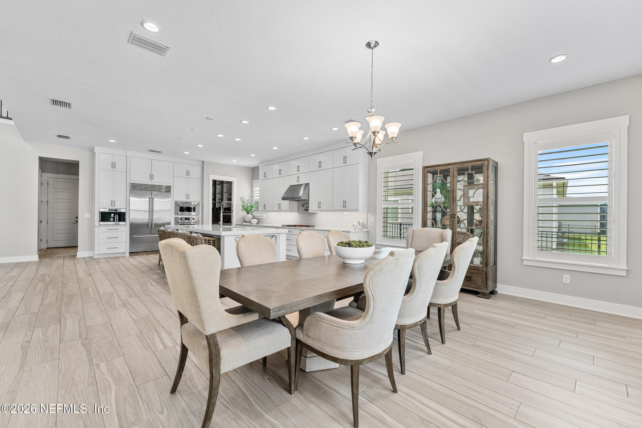 245 Ranch Land Circle St. Johns, FL 32259 - Photo 21 of 74 a view of a dining room with furniture wooden floor and chandelier