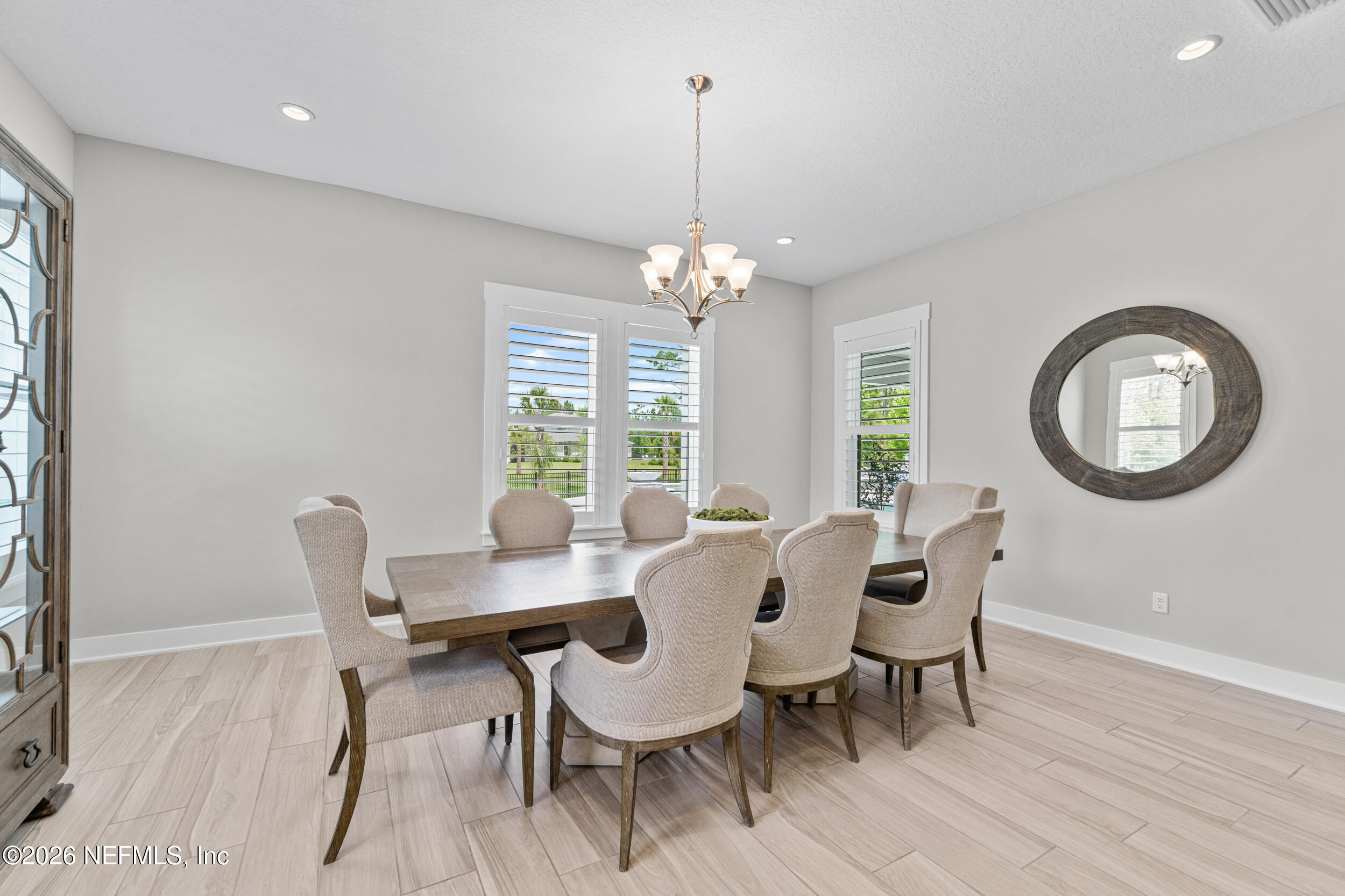 245 Ranch Land Circle St. Johns, FL 32259 - Photo 22 of 74 a dining room with furniture a chandelier and wooden floor
