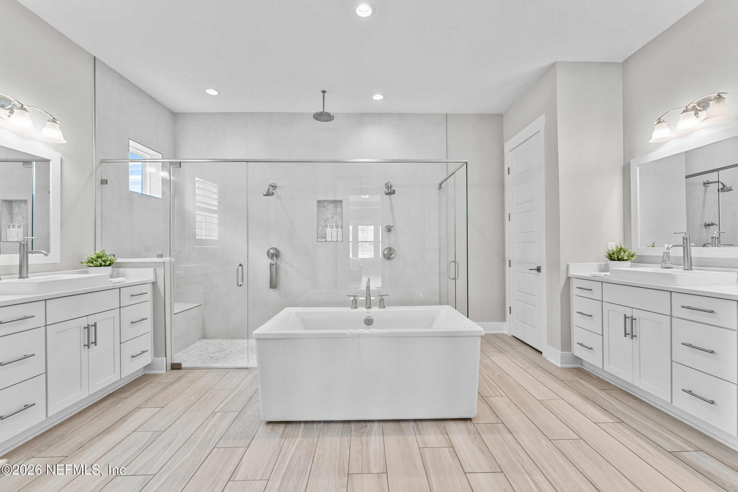 245 Ranch Land Circle St. Johns, FL 32259 - Photo 25 of 74 a spacious bathroom with a double vanity sink a mirror and a bathtub