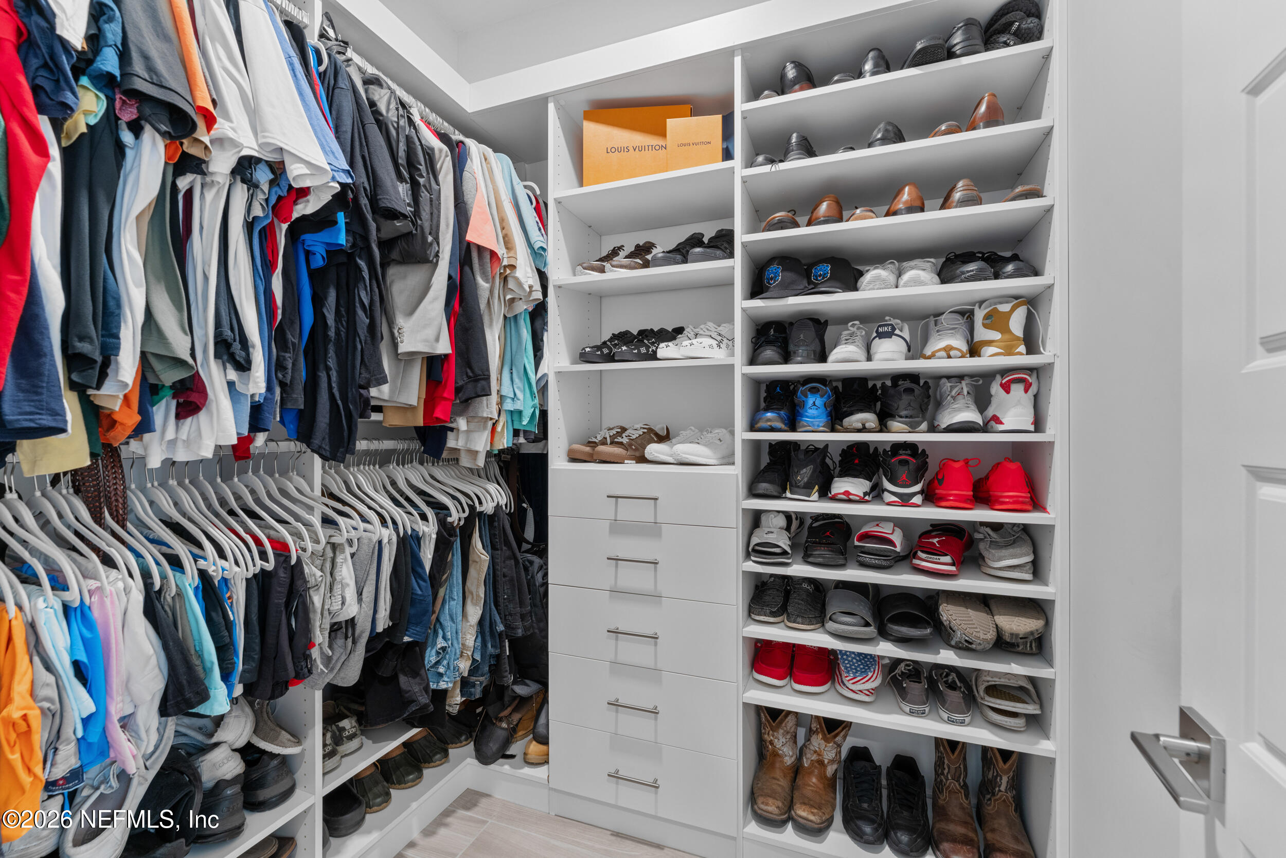 245 Ranch Land Circle St. Johns, FL 32259 - Photo 28 of 74 a view of walk in closet with clothes and shoes