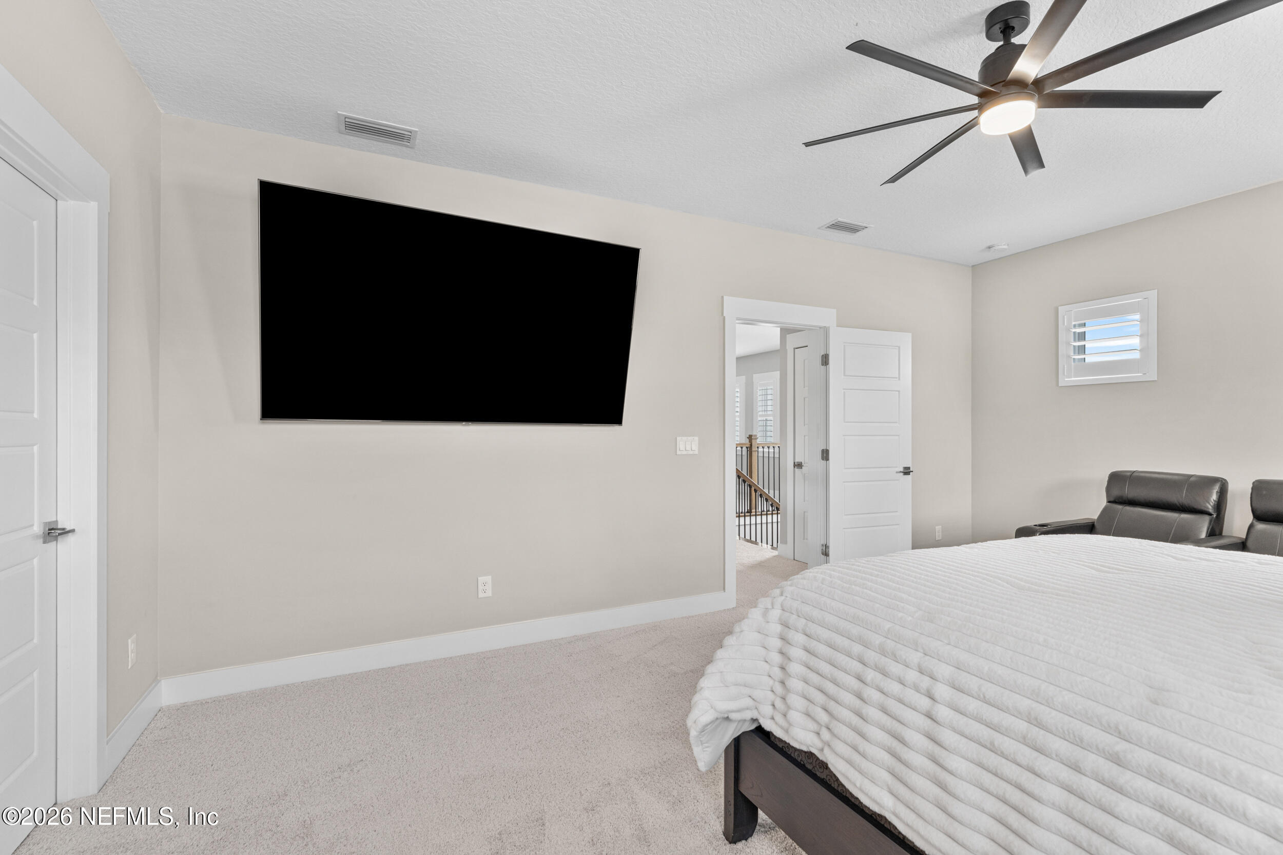 245 Ranch Land Circle St. Johns, FL 32259 - Photo 33 of 74 a bedroom with a bed and a flat screen tv