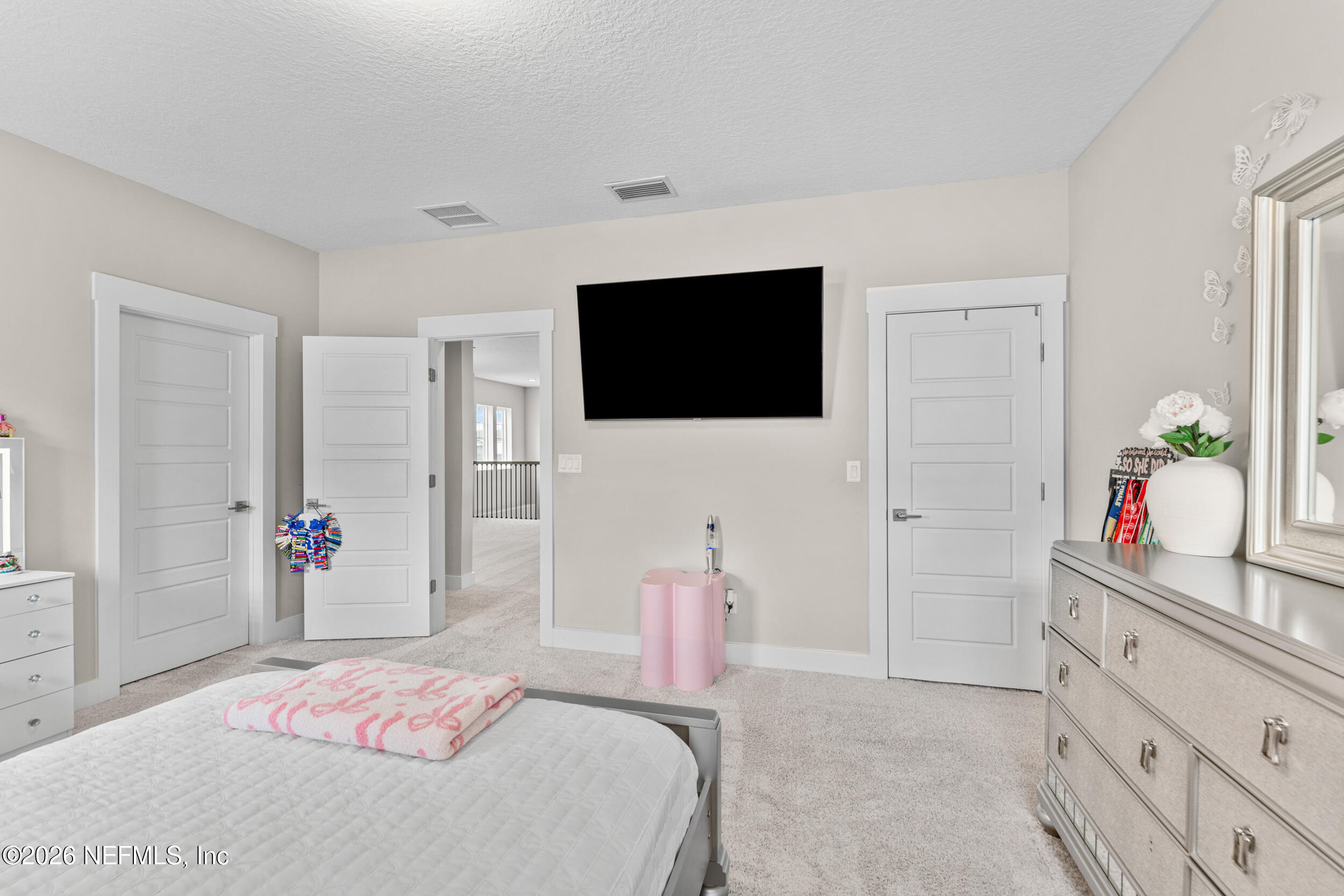 245 Ranch Land Circle St. Johns, FL 32259 - Photo 36 of 74 a bedroom with a bed and a flat screen tv