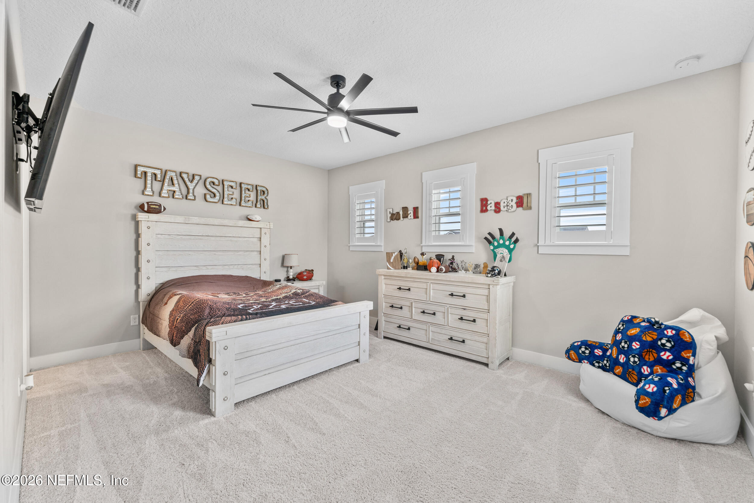 245 Ranch Land Circle St. Johns, FL 32259 - Photo 38 of 74 a bedroom with a bed and a chandelier