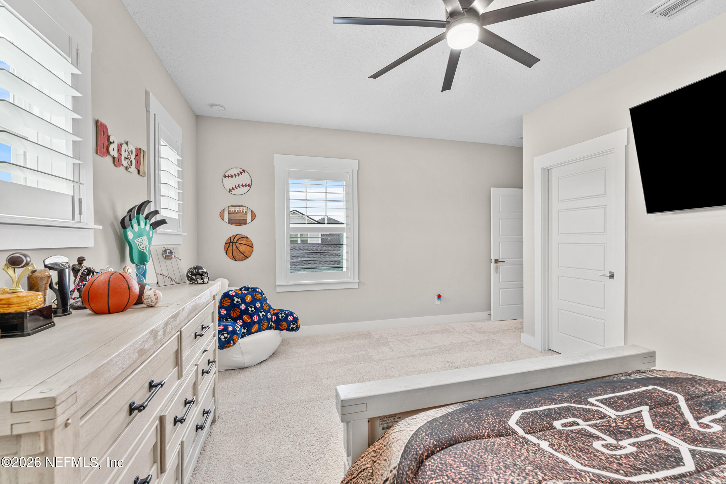 245 Ranch Land Circle St. Johns, FL 32259 - Photo 39 of 74 a bedroom with a bed and flat screen tv
