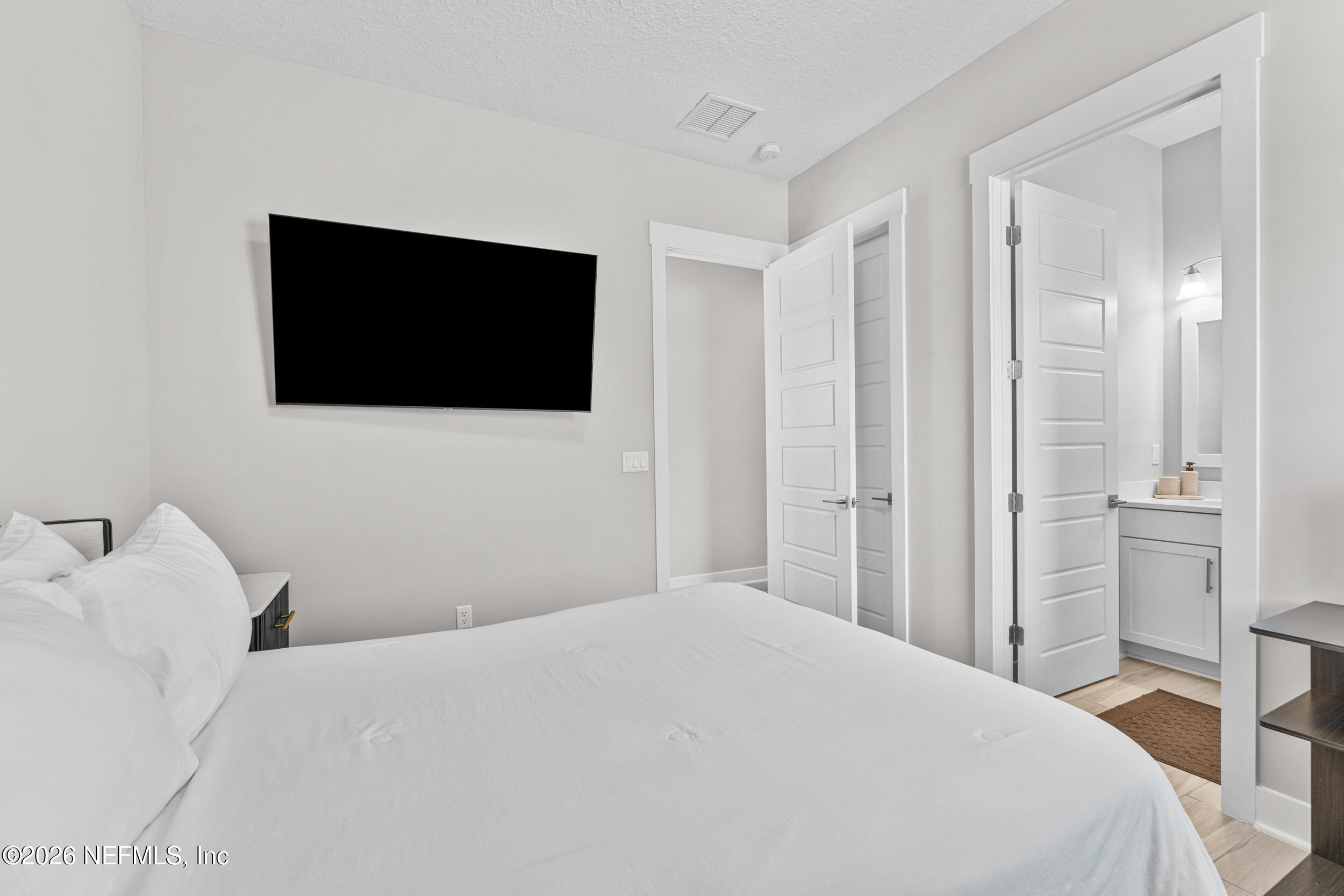 245 Ranch Land Circle St. Johns, FL 32259 - Photo 42 of 74 a bedroom with a bed and a flat screen tv