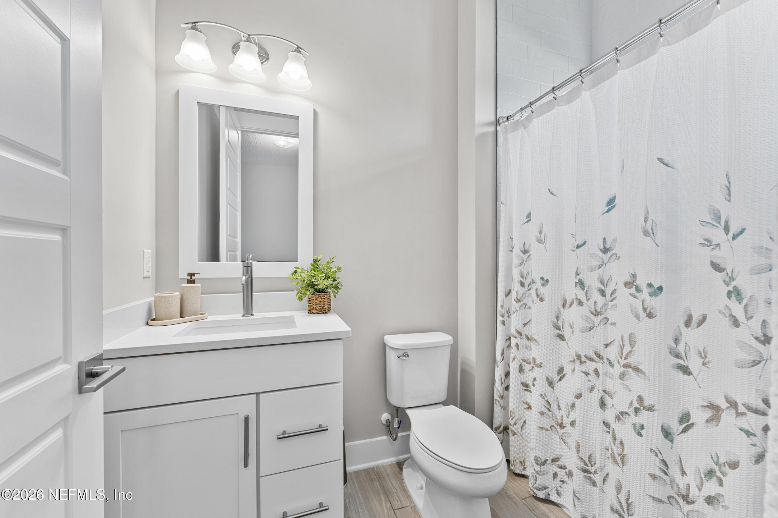 245 Ranch Land Circle St. Johns, FL 32259 - Photo 43 of 74 a bathroom with a toilet sink and mirror