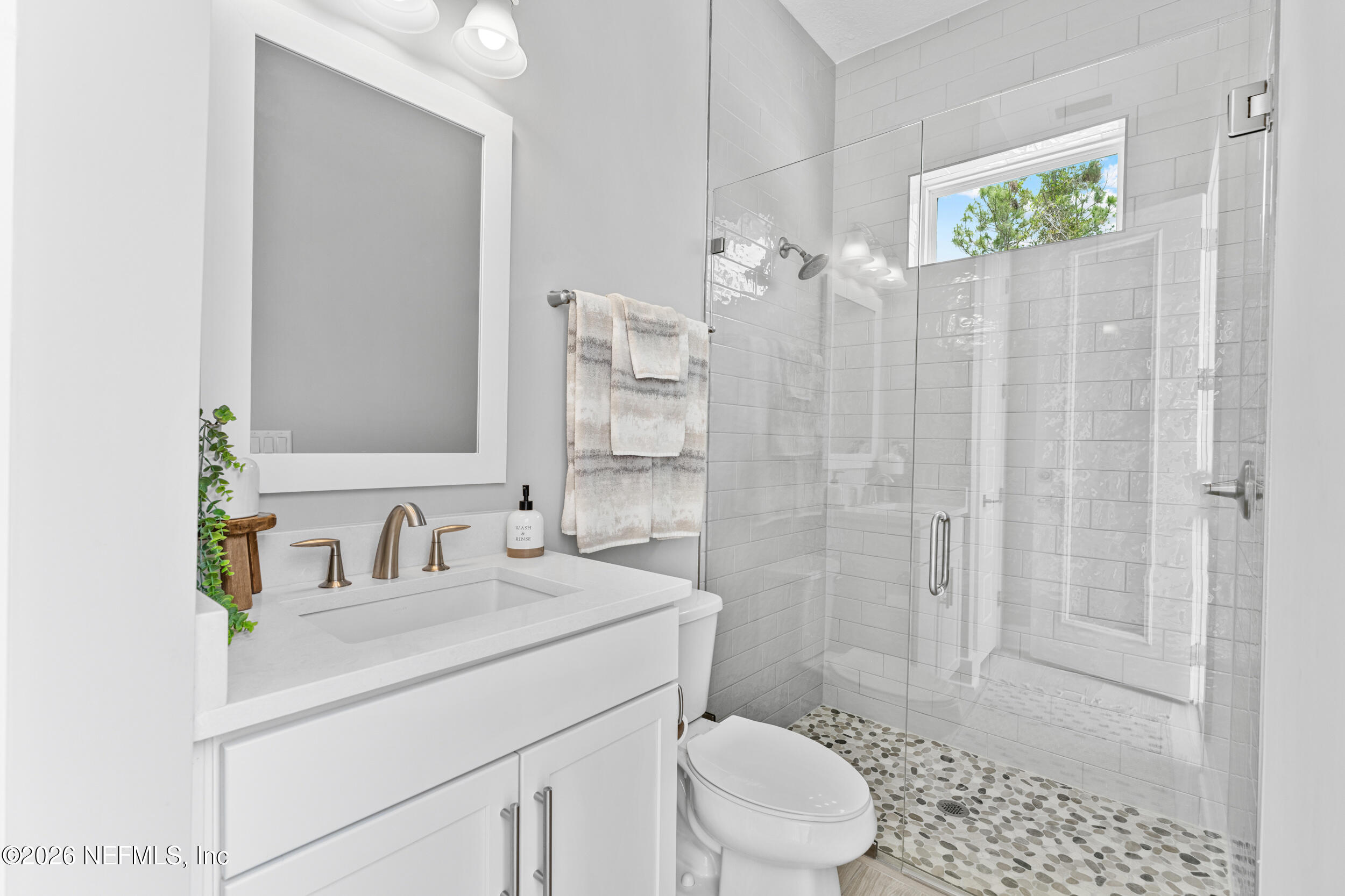 245 Ranch Land Circle St. Johns, FL 32259 - Photo 48 of 74 a bathroom with a sink a toilet and shower