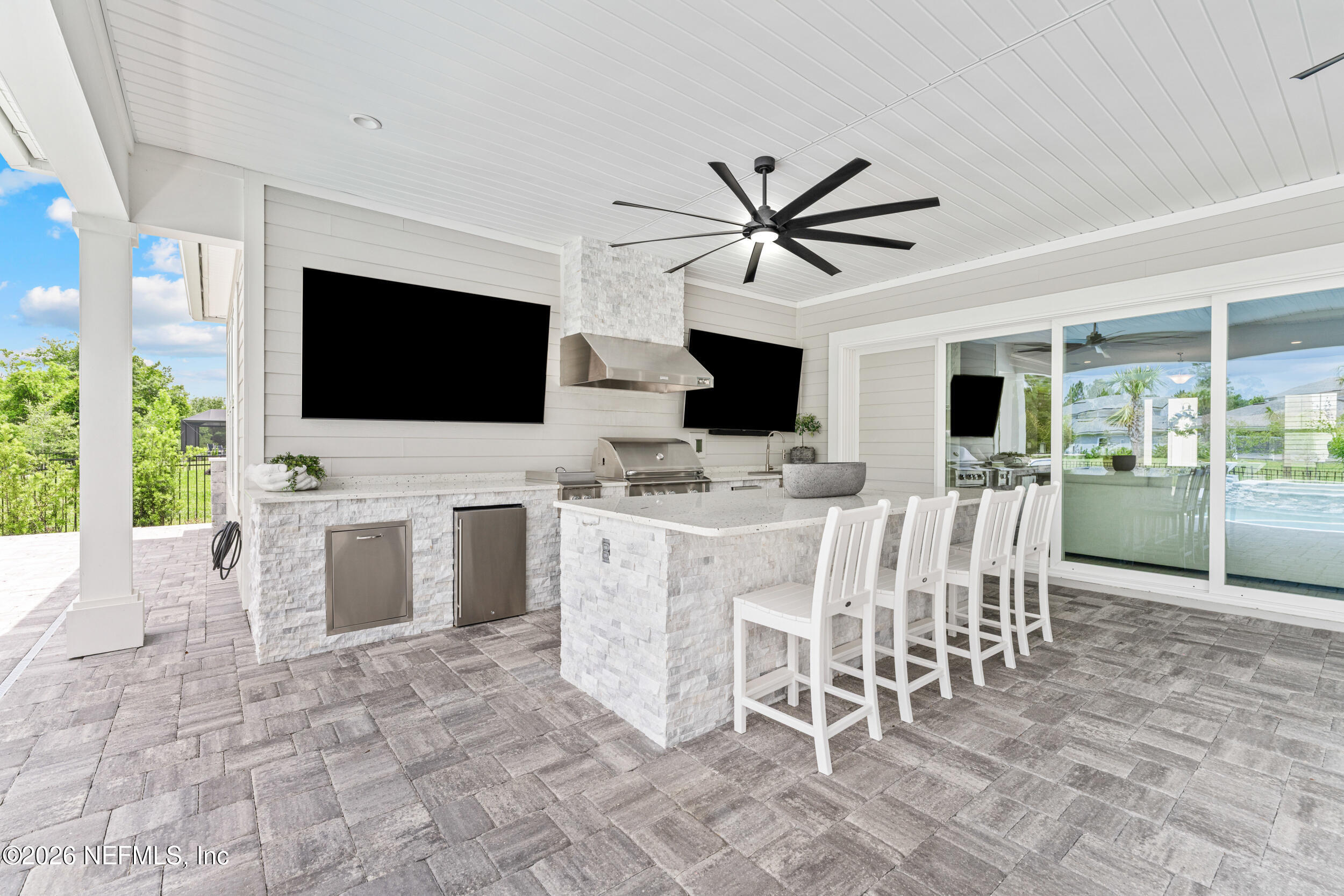 245 Ranch Land Circle St. Johns, FL 32259 - Photo 51 of 74 a view of a dining room with furniture and a flat screen tv