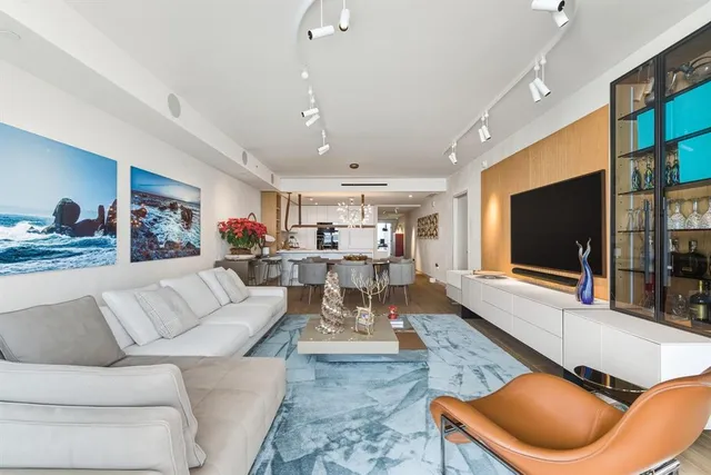 a bedroom with furniture and a large window