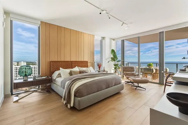 a living room with furniture and a floor to ceiling window
