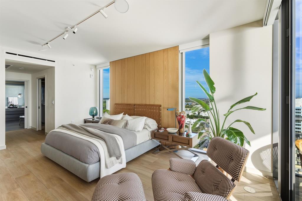 1116 North Ocean Boulevard, Unit 1506 Pompano Beach, FL 33062 - Photo 18 of 69 a bedroom with bed and a potted plant