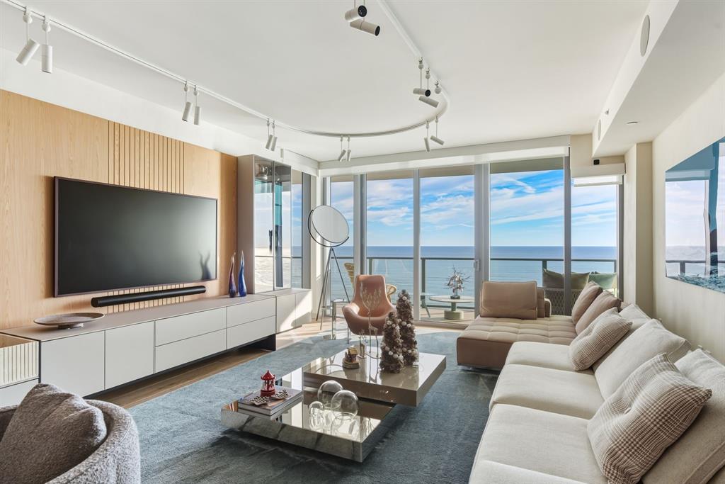 1116 North Ocean Boulevard, Unit 1506 Pompano Beach, FL 33062 - Photo 2 of 69 a living room with furniture and a flat screen tv