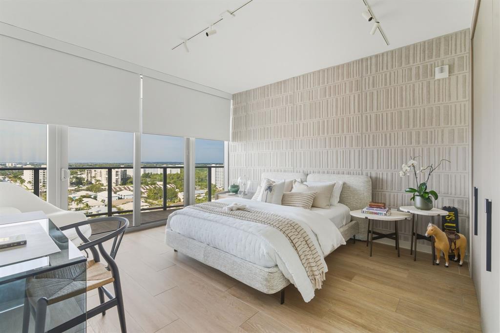 1116 North Ocean Boulevard, Unit 1506 Pompano Beach, FL 33062 - Photo 37 of 69 a bedroom with a bed and large windows
