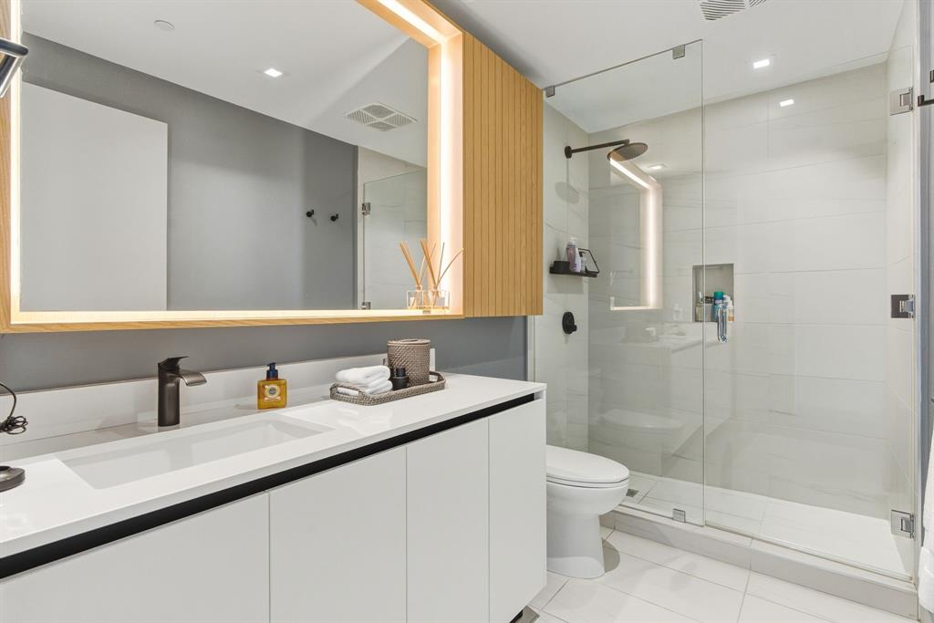 1116 North Ocean Boulevard, Unit 1506 Pompano Beach, FL 33062 - Photo 44 of 69 a bathroom with a sink a toilet and shower