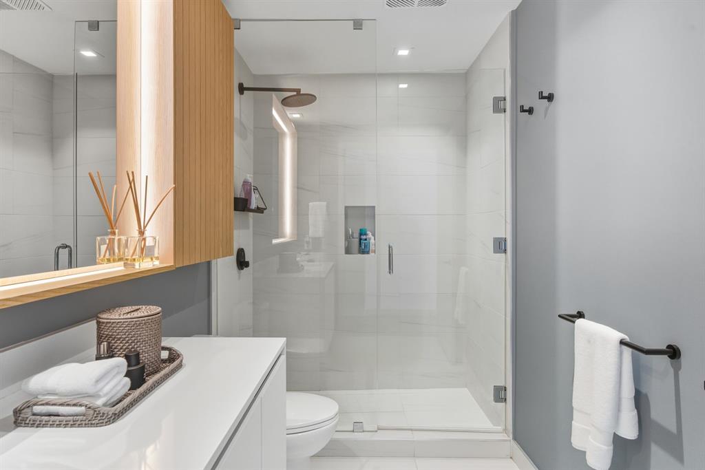 1116 North Ocean Boulevard, Unit 1506 Pompano Beach, FL 33062 - Photo 45 of 69 a bathroom with a sink toilet and shower