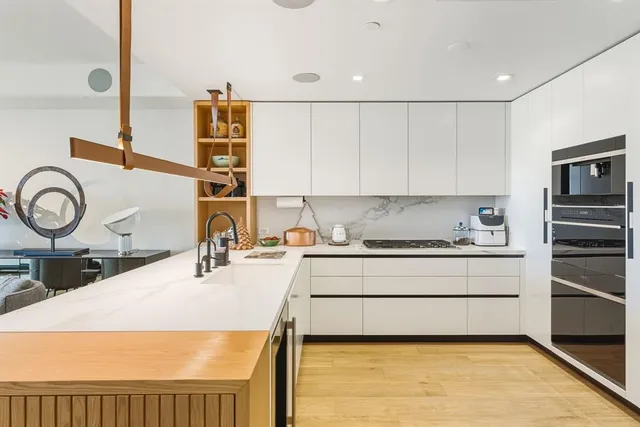 a kitchen with a stove a sink and a refrigerator