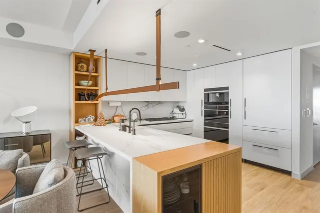 a living room with furniture a chandelier and a table