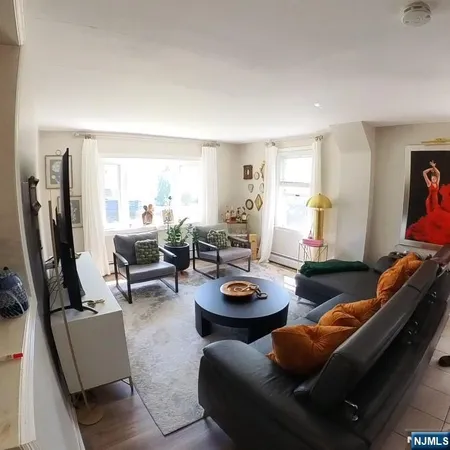 a kitchen with stainless steel appliances granite countertop a stove a refrigerator a sink a stove a dining table and chairs