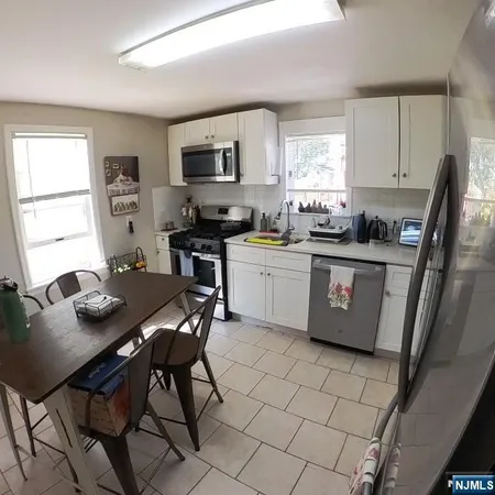 a view of a dining room with furniture and window