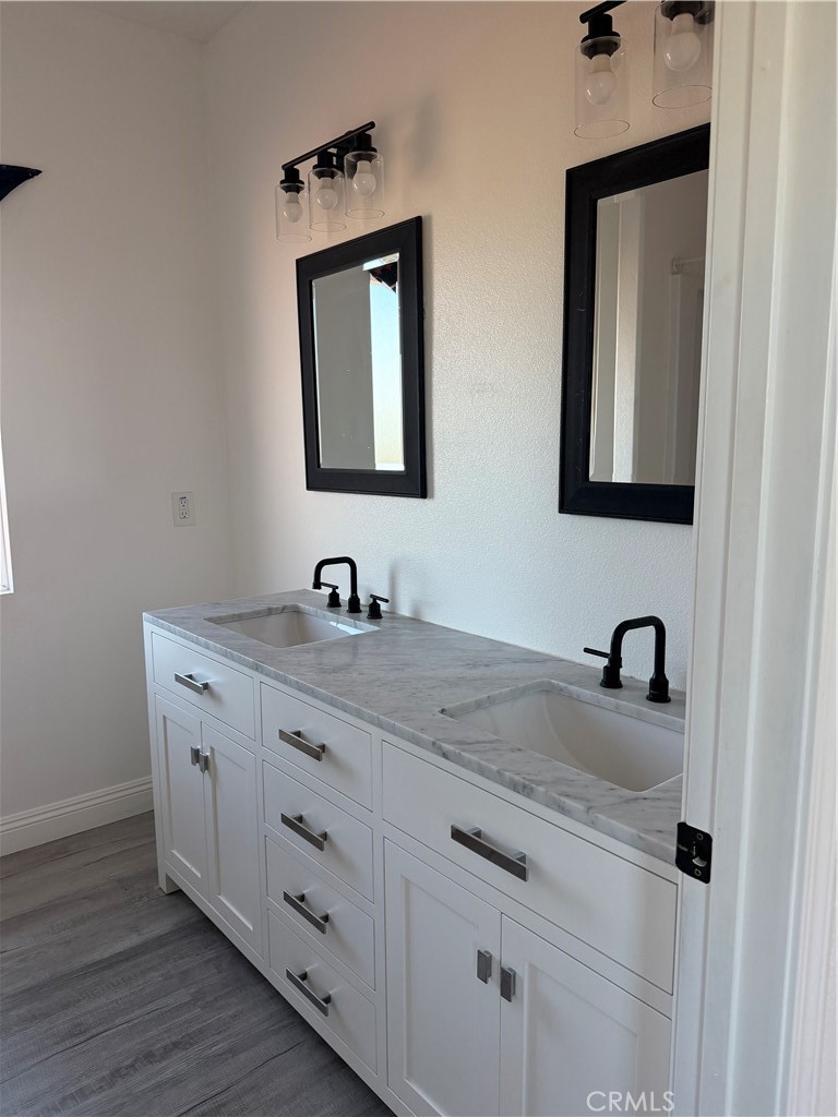 12690 7th Street Yucaipa, CA 92399 - Photo 4 of 7 a bathroom with a granite countertop sink vanity and mirror