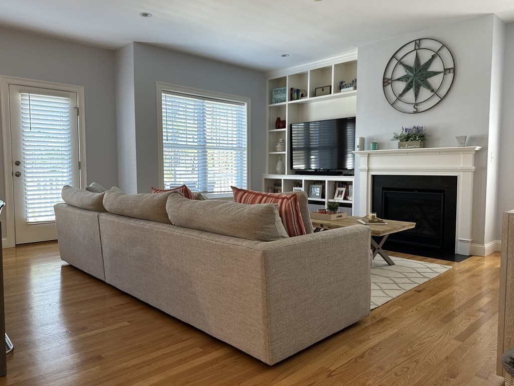 47 Quarry Road, Unit 47 Acton, MA 01720 - Photo 4 of 15 a living room with furniture a flat screen tv and a fireplace