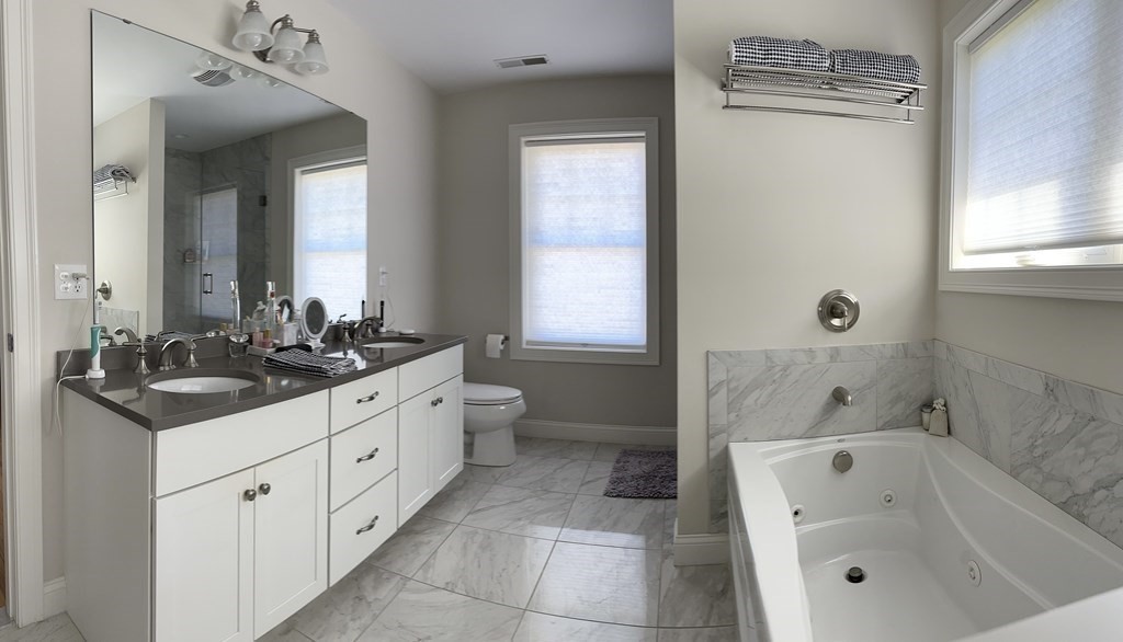 47 Quarry Road, Unit 47 Acton, MA 01720 - Photo 10 of 15 a bathroom with a granite countertop sink a toilet and bathtub