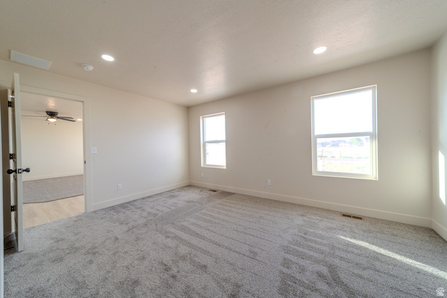 130 Pole Line Road, Unit 2 Roosevelt, UT 84066 - Photo 17 of 33 Spacious room featuring neutral carpeting and light-colored walls