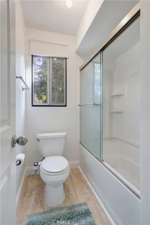 a bathroom with a toilet and a shower