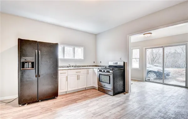 a kitchen with stainless steel appliances granite countertop a refrigerator stove and sink