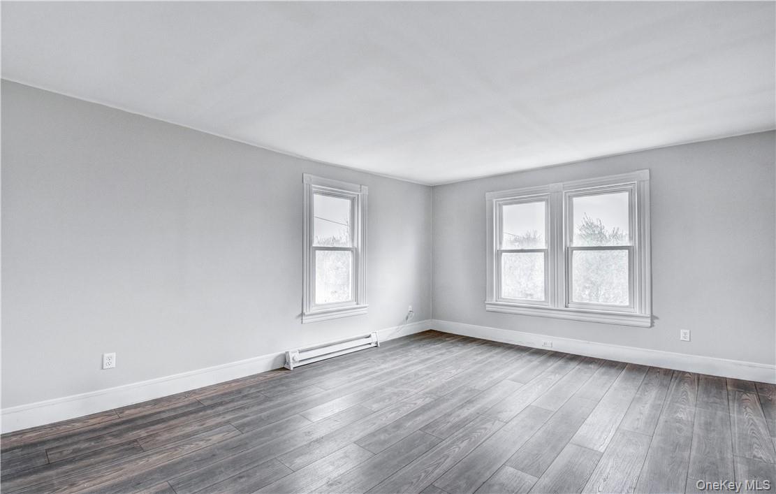 202 Midland Lake Road Middletown, NY 10941 - Photo 12 of 26 an empty room with wooden floor and windows