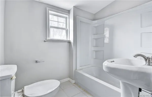 a bathroom with a sink a toilet and bathtub