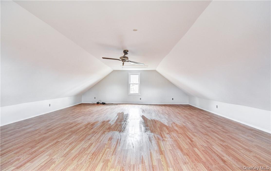 202 Midland Lake Road Middletown, NY 10941 - Photo 19 of 26 an empty room with wooden floor ceiling fan and windows