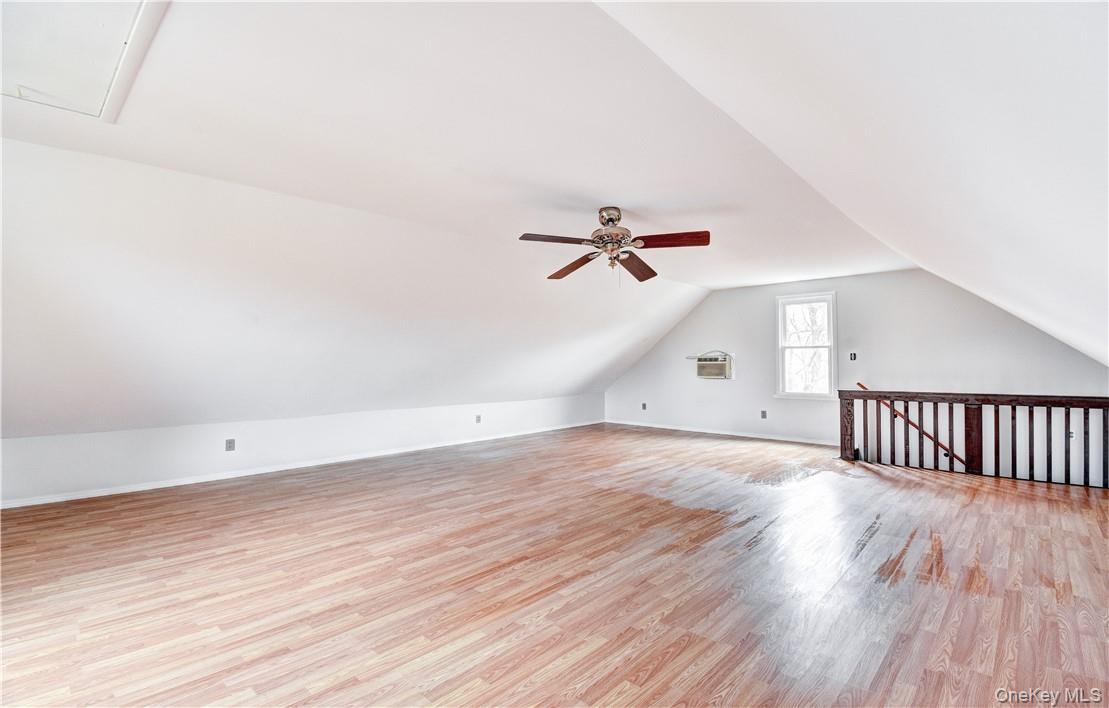 202 Midland Lake Road Middletown, NY 10941 - Photo 20 of 26 an empty room with wooden floor fan and windows