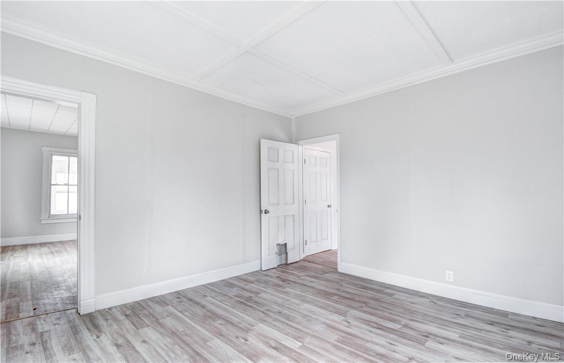 202 Midland Lake Road Middletown, NY 10941 - Photo 8 of 26 an empty room with wooden floor and windows