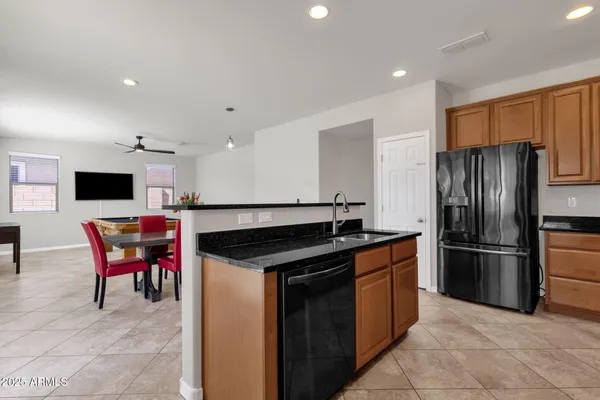 a kitchen with stainless steel appliances granite countertop a stove a sink and a refrigerator