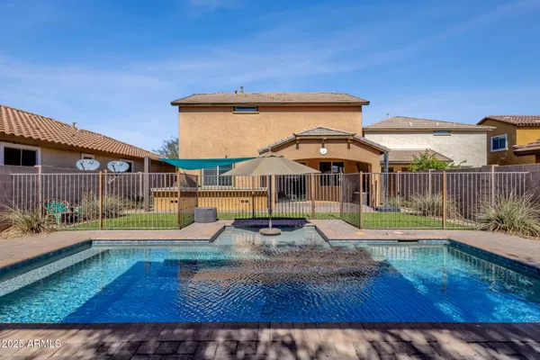 a view of a backyard with swimming pool