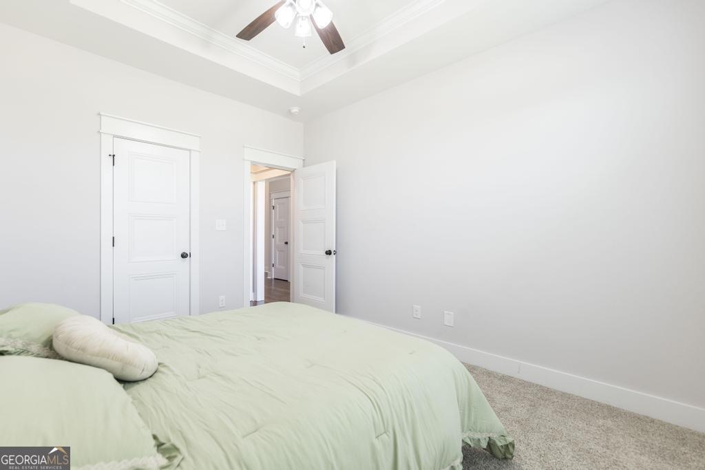 113 Flat Rock Lane Perry, GA 31069 - Photo 11 of 39 a bedroom with a bed and a ceiling fan