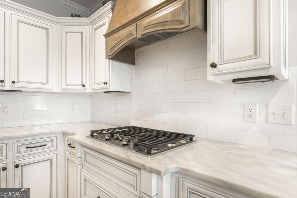 113 Flat Rock Lane Perry, GA 31069 - Photo 18 of 39 a kitchen with white cabinets and appliances