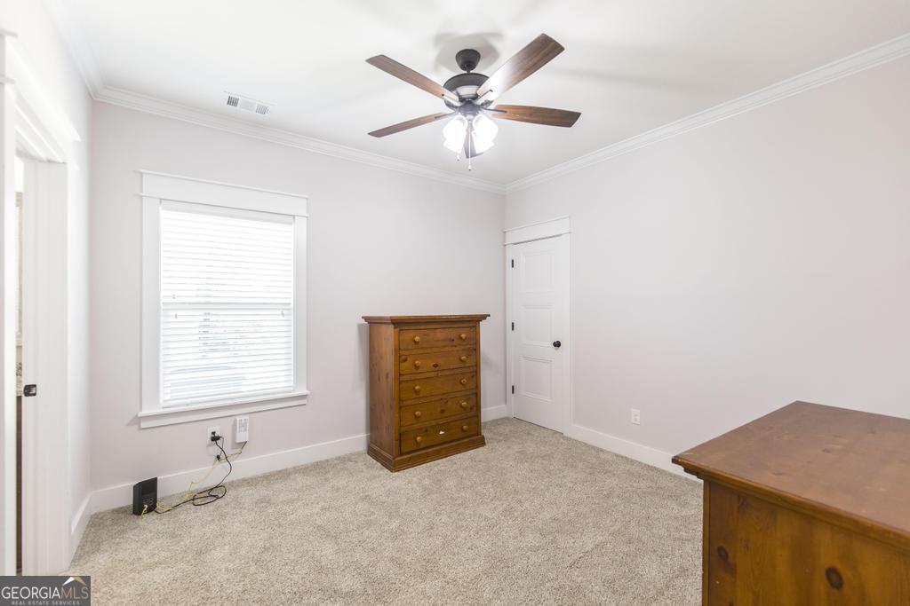 113 Flat Rock Lane Perry, GA 31069 - Photo 22 of 39 an empty room with windows and fan