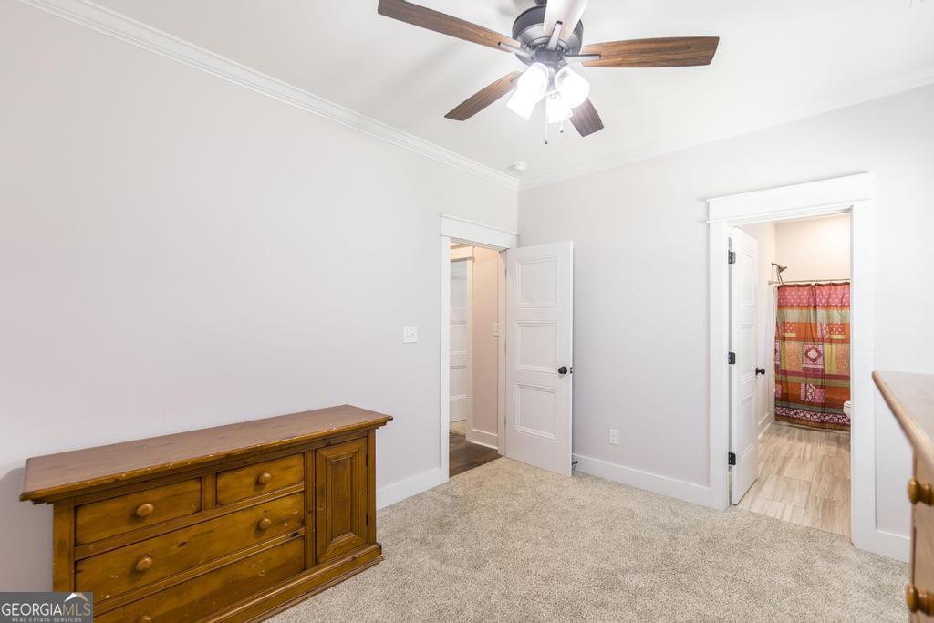 113 Flat Rock Lane Perry, GA 31069 - Photo 23 of 39 an empty room with closet and a ceiling fan