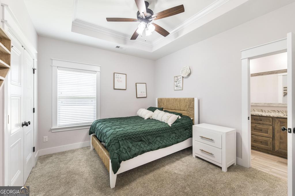 113 Flat Rock Lane Perry, GA 31069 - Photo 25 of 39 a bedroom with a bed dresser and a window