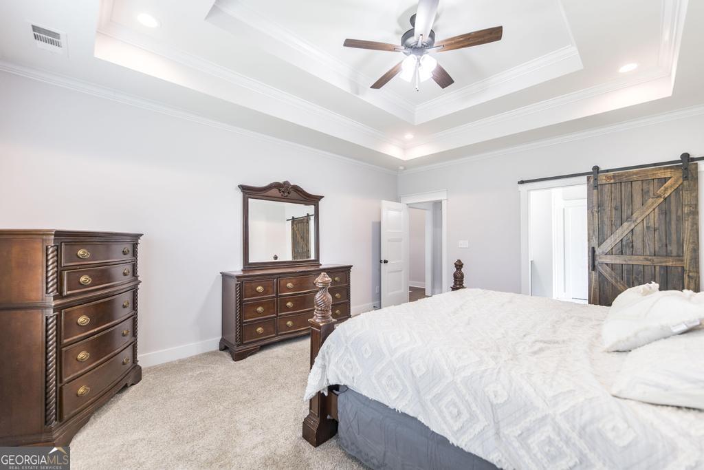 113 Flat Rock Lane Perry, GA 31069 - Photo 28 of 39 a bedroom with a bed and a dresser