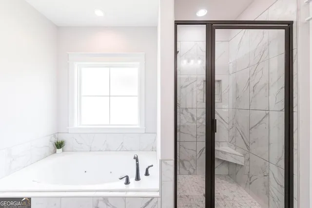 a white bath tub sitting next to a window