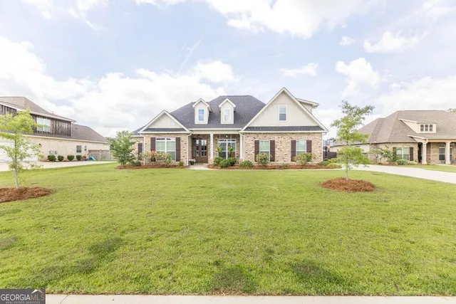 a front view of a house with swimming pool having outdoor seating