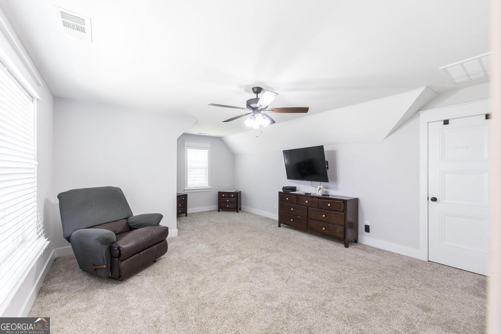 113 Flat Rock Lane Perry, GA 31069 - Photo 31 of 39 a living room with furniture and a flat screen tv