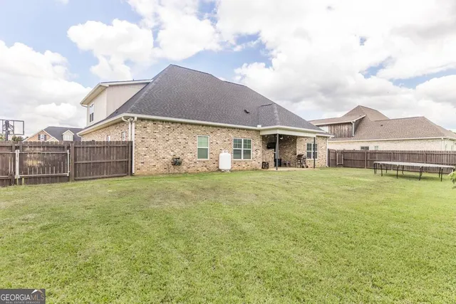 a view of a house with a garden and plants